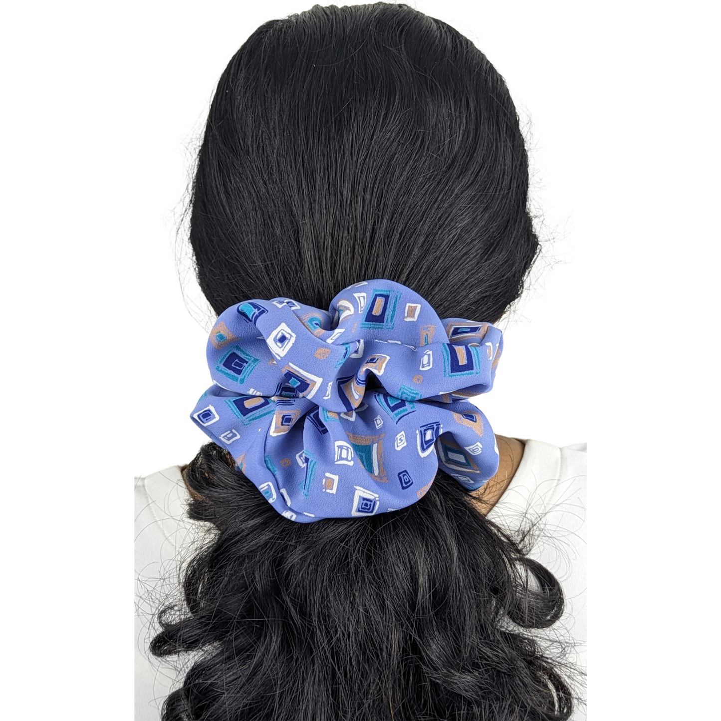 Woman wearing large light blue scrunchie made with 100% polyester fabric.